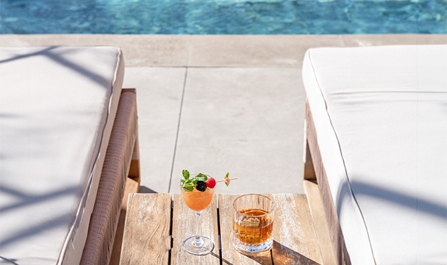 Relax and unwind poolside cocktails on a table at a pool